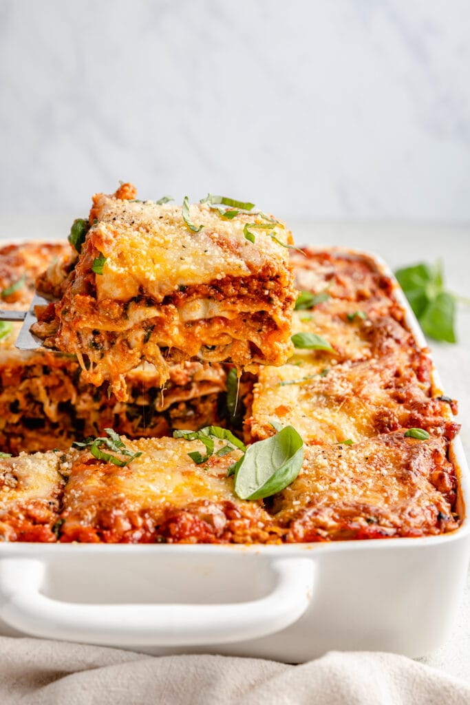 slice of lasagna being lifted out of pan