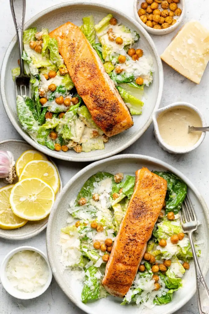 salmon Caesar salads in bowls