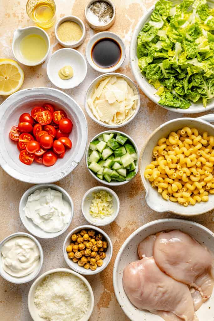 chicken caesar pasta salad ingredients in small bowls