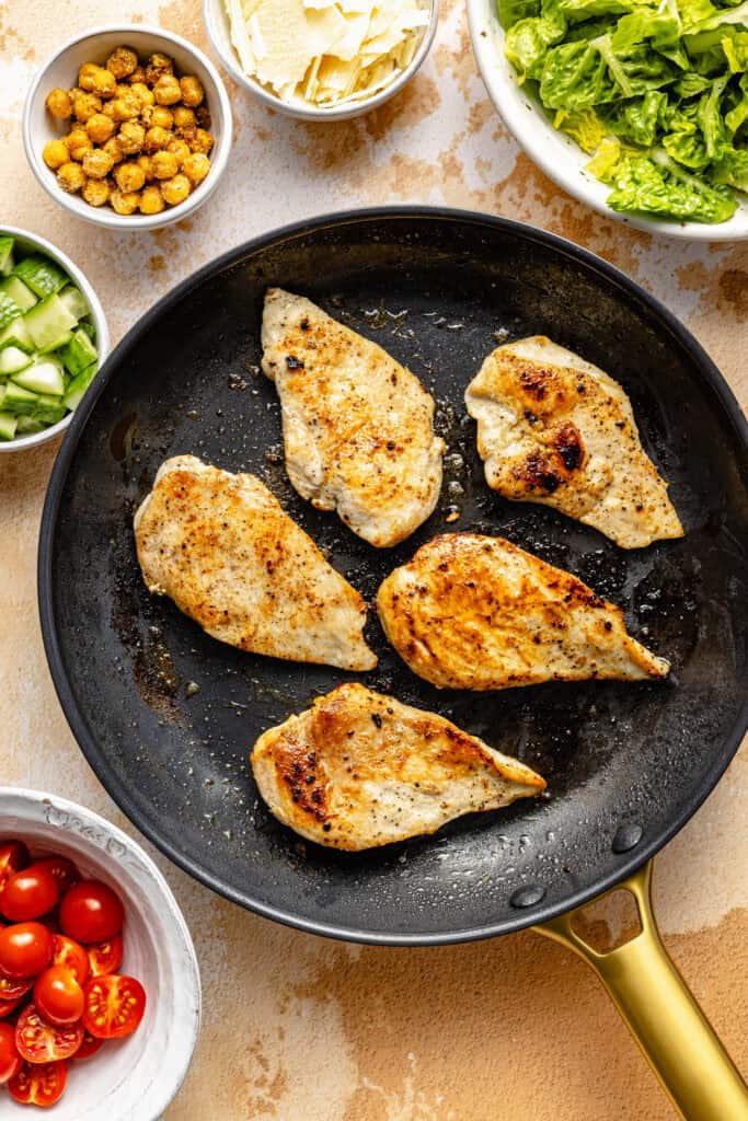 chicken being cooked in skillet