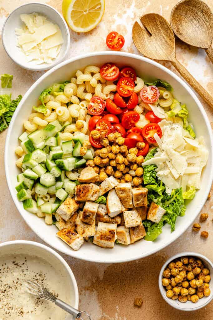 chicken caesar pasta salad ingredients in bowl