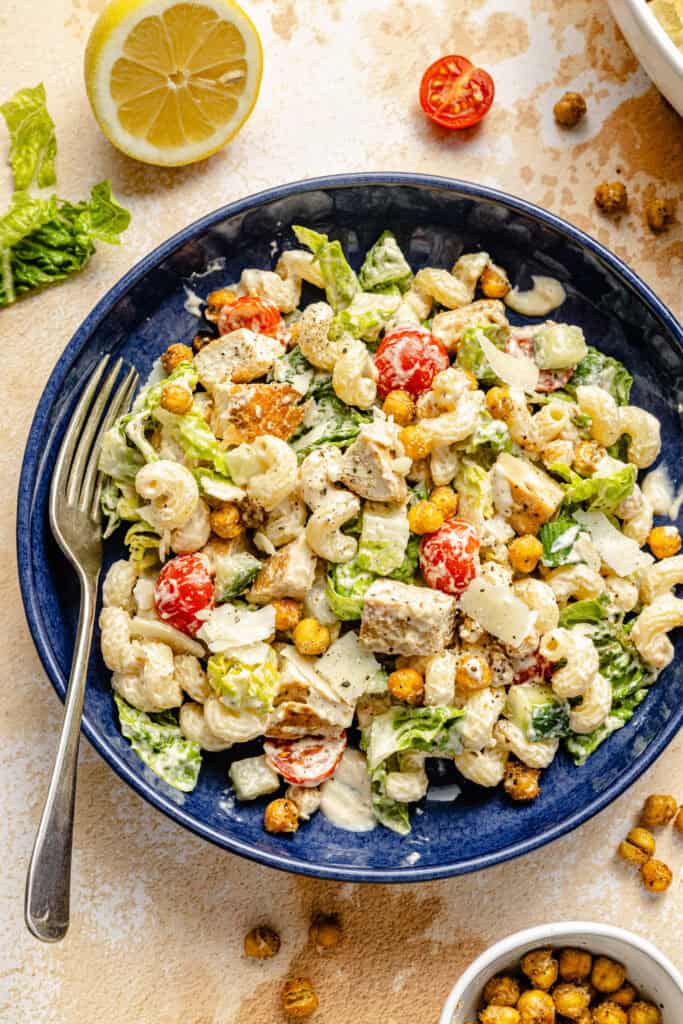 chicken caesar pasta salad in bowl with fork