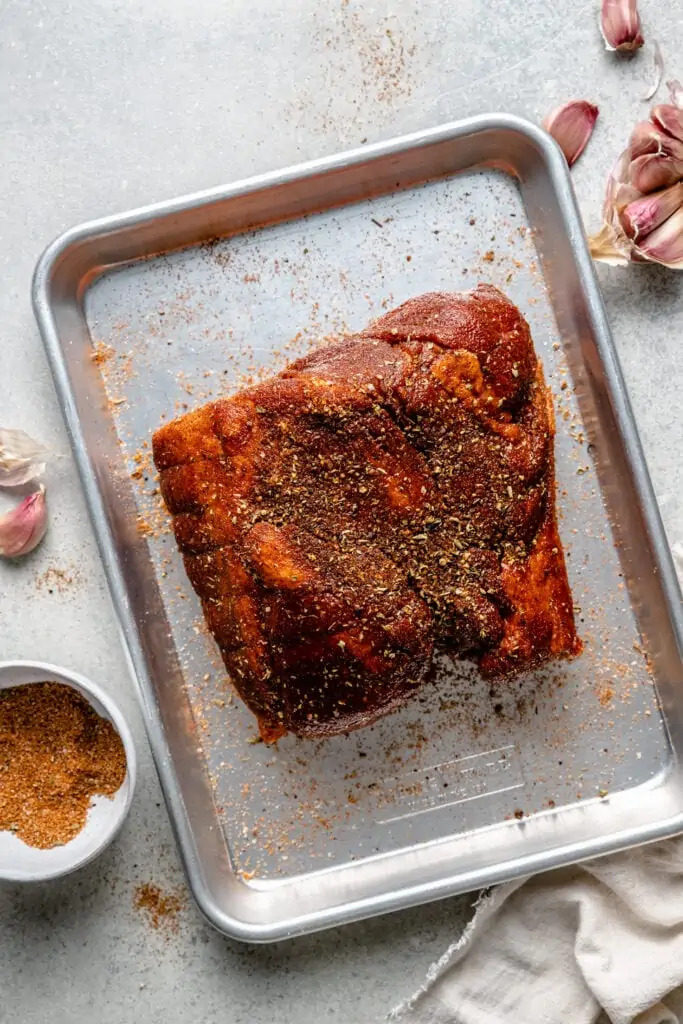 pork shoulder on with spices on sheet pan