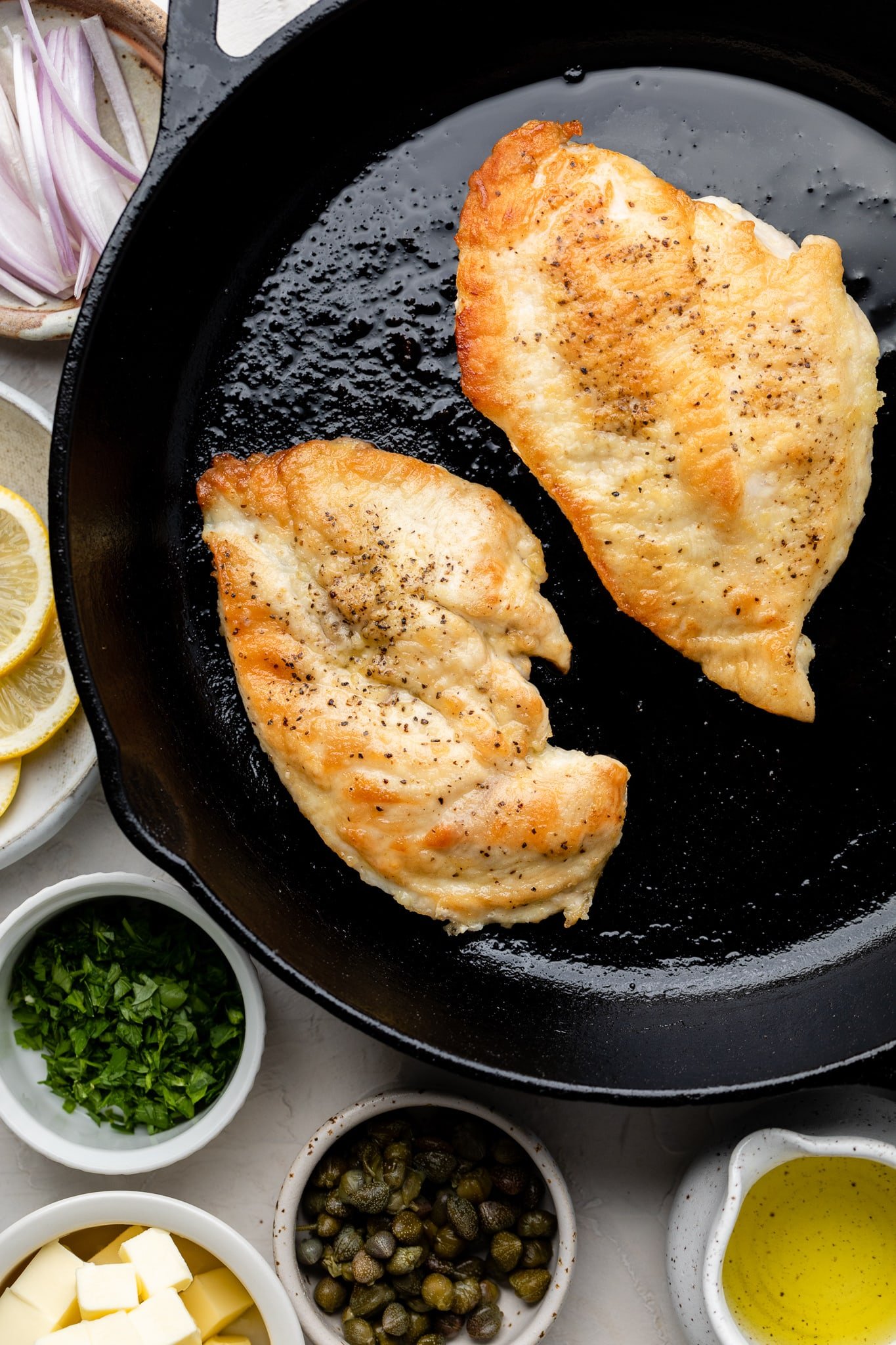 chicken breast being seared in pan