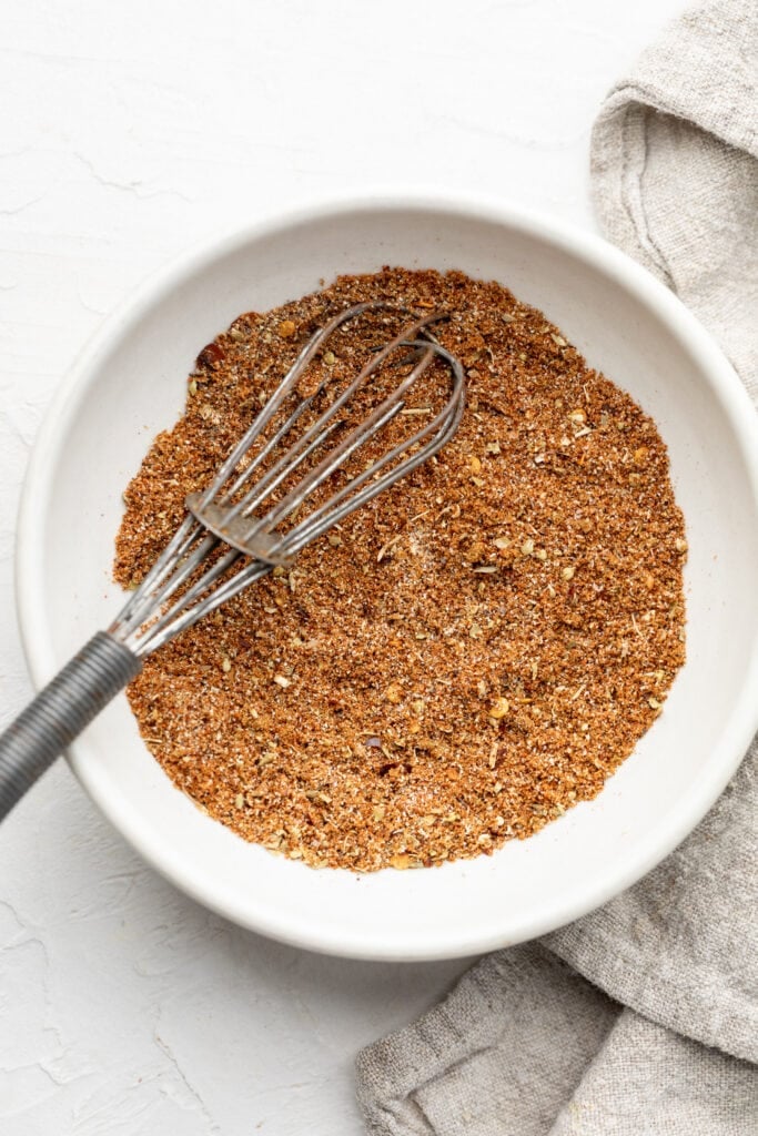 taco seasoning in bowl with whisk