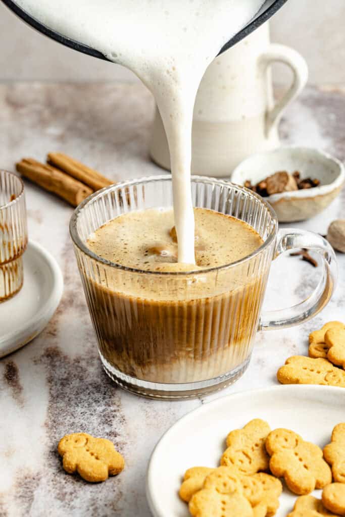 frothed milk being poured into coffee