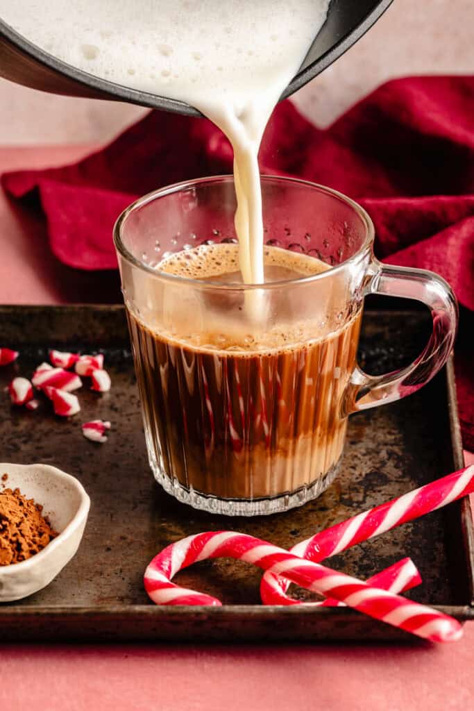 milk being poured into coofee