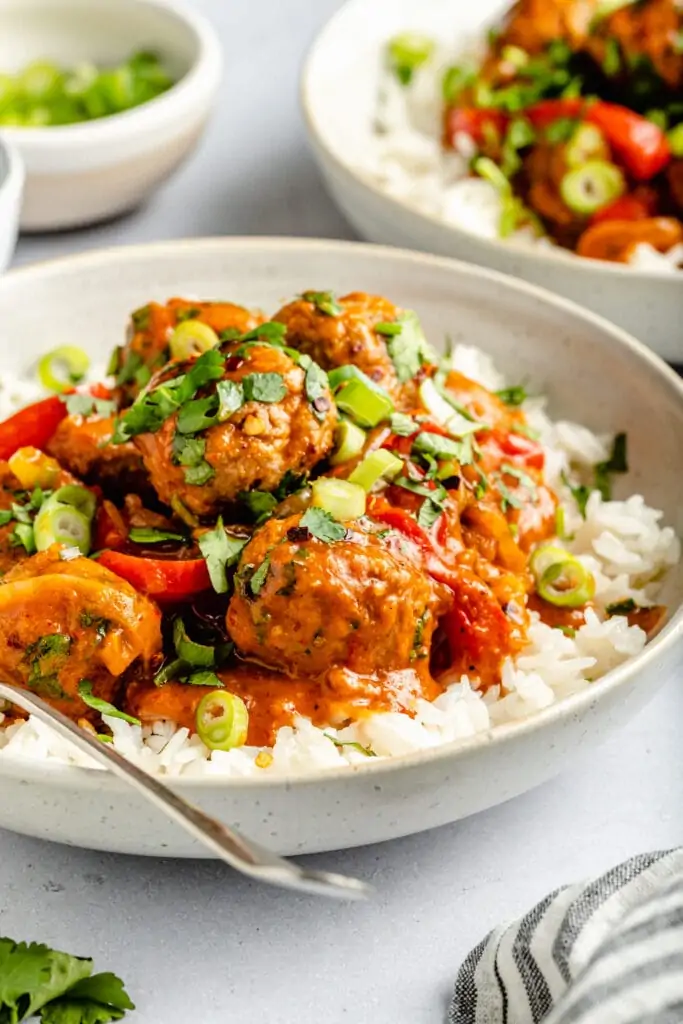 red curry meatballs over rice in bowl