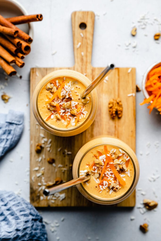 carrot cake smoothie in glasses on cutting board