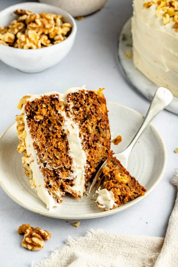 slice of carrot cake on plate with fork