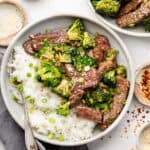 beef and broccoli in bowl over rice