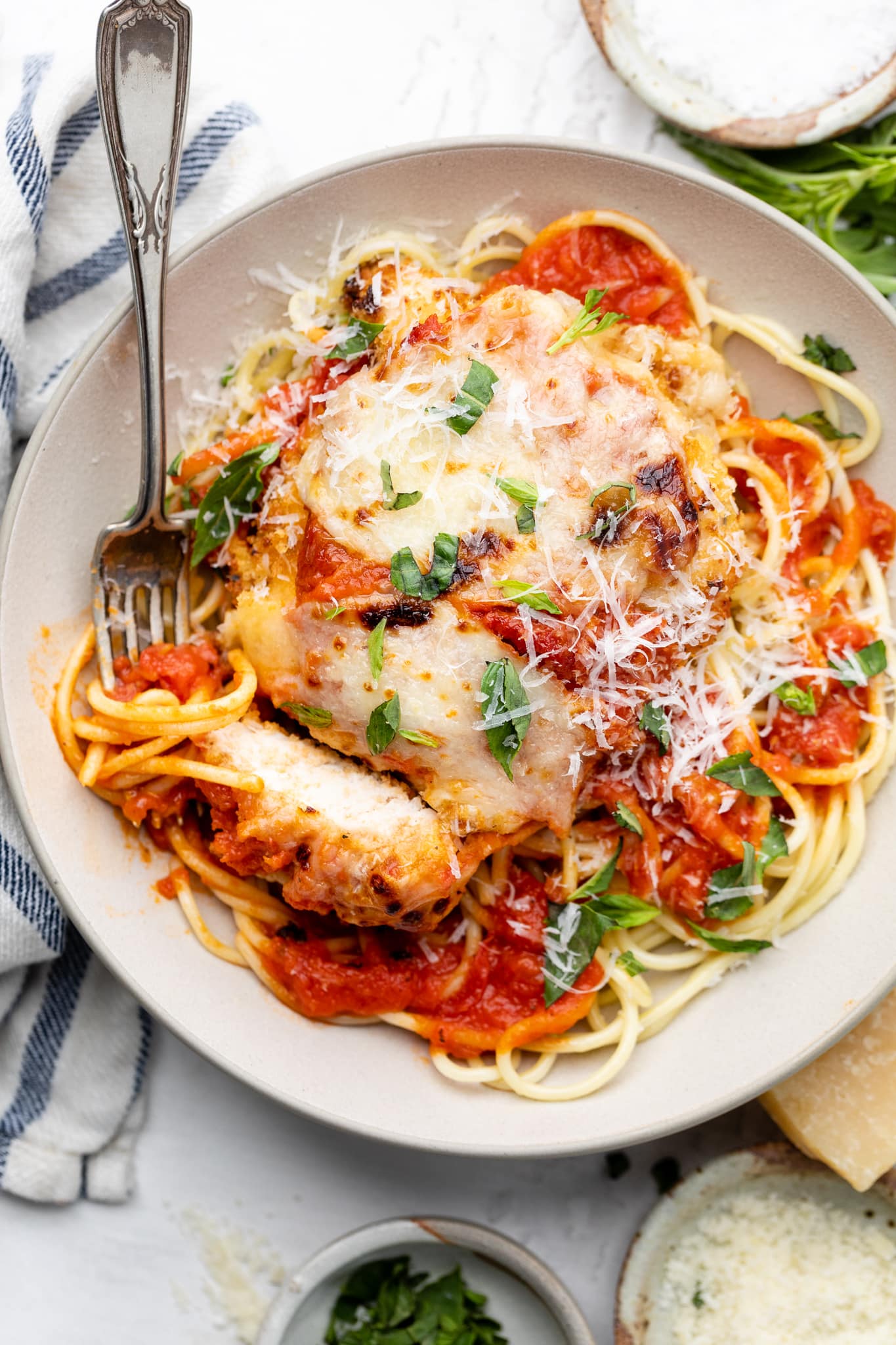 chicken parmesan in bowl with pasta