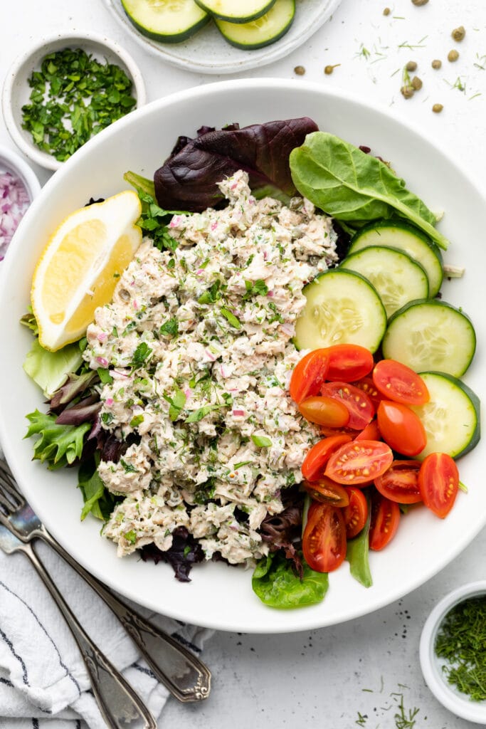 tuna salad over greens in bowl