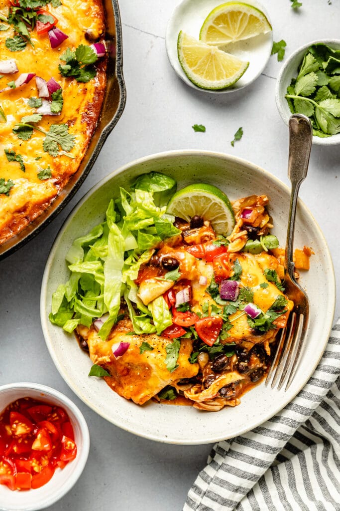 enchilada skillet served with lettuce and toppings