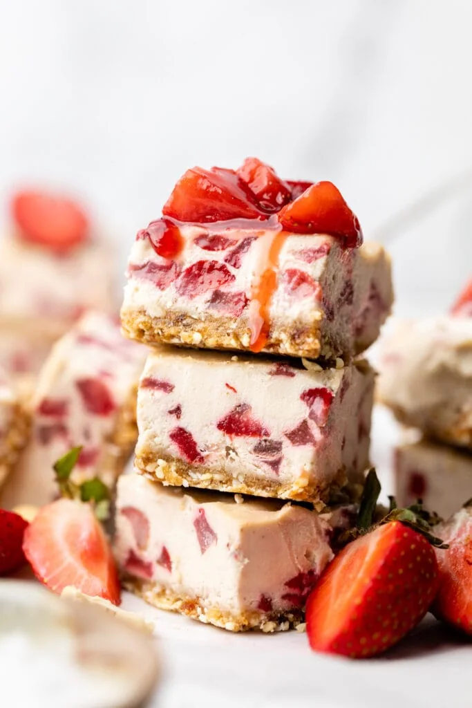 strawberry cheesecake bars stacked on each other