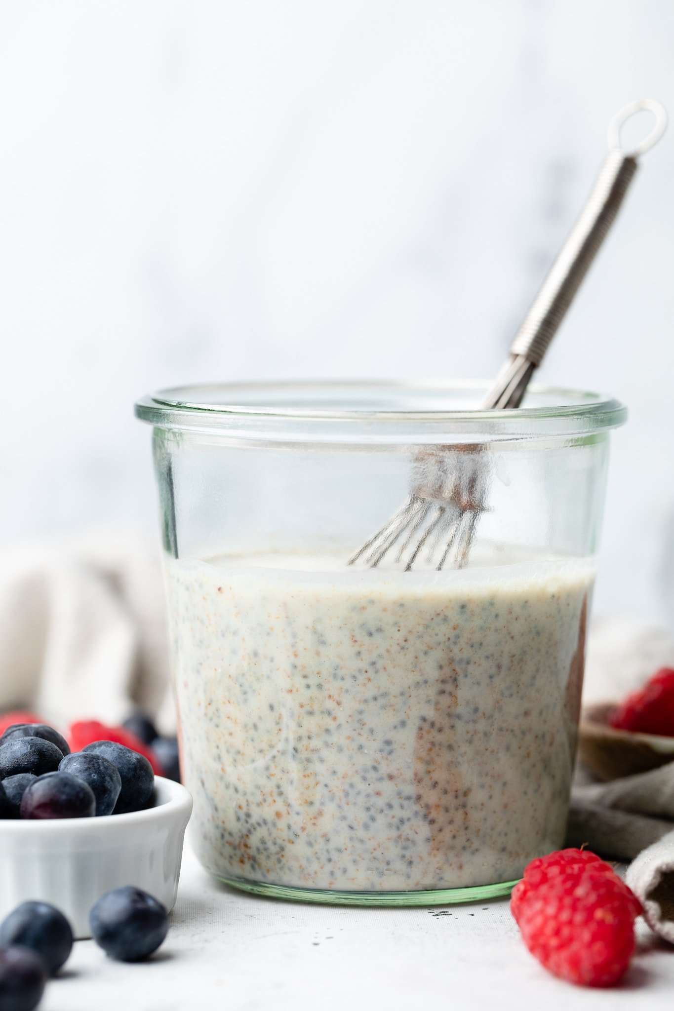 chia seed pudding in jar with whisk