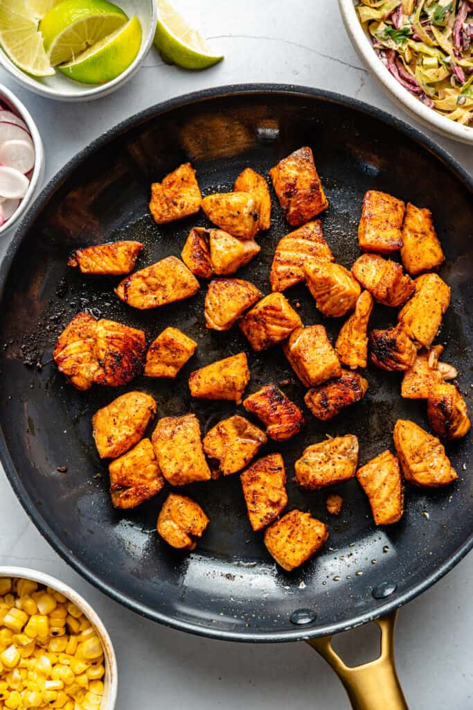 salmon pieces in skillet 