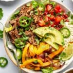 beef burrito bowl with toppings and fork