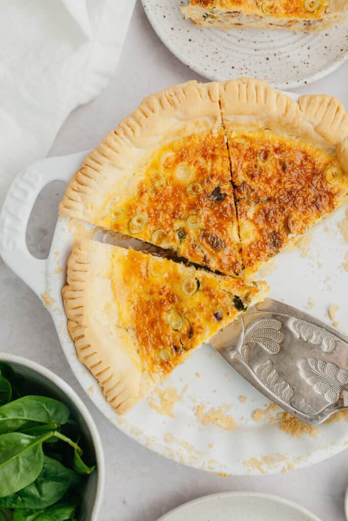 quiche in pie plate with spatula