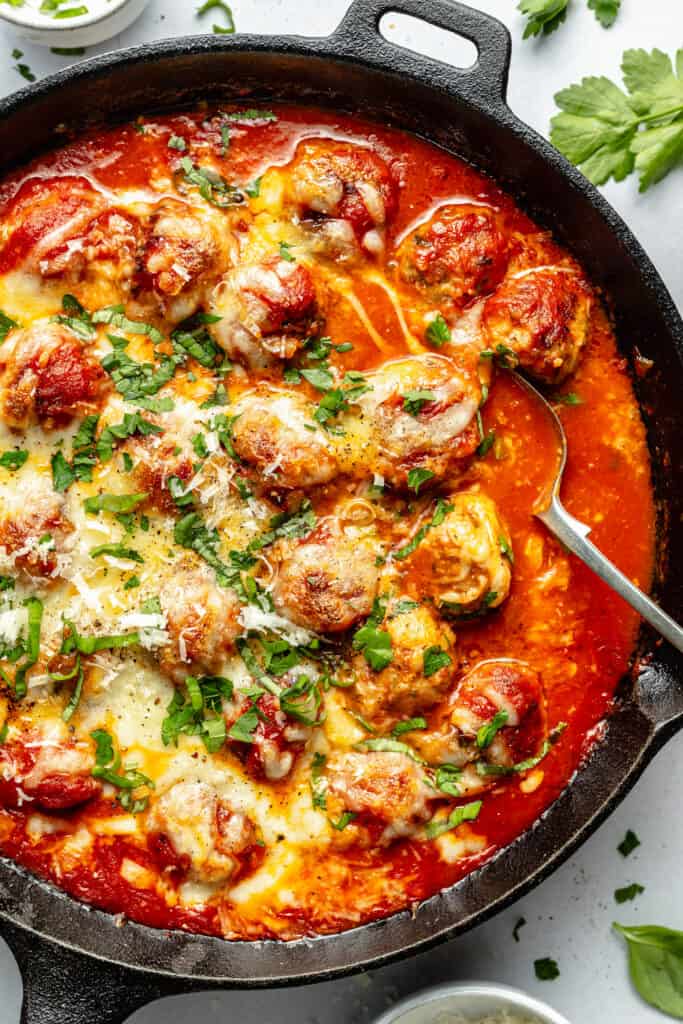 meatballs in skillet with spoon