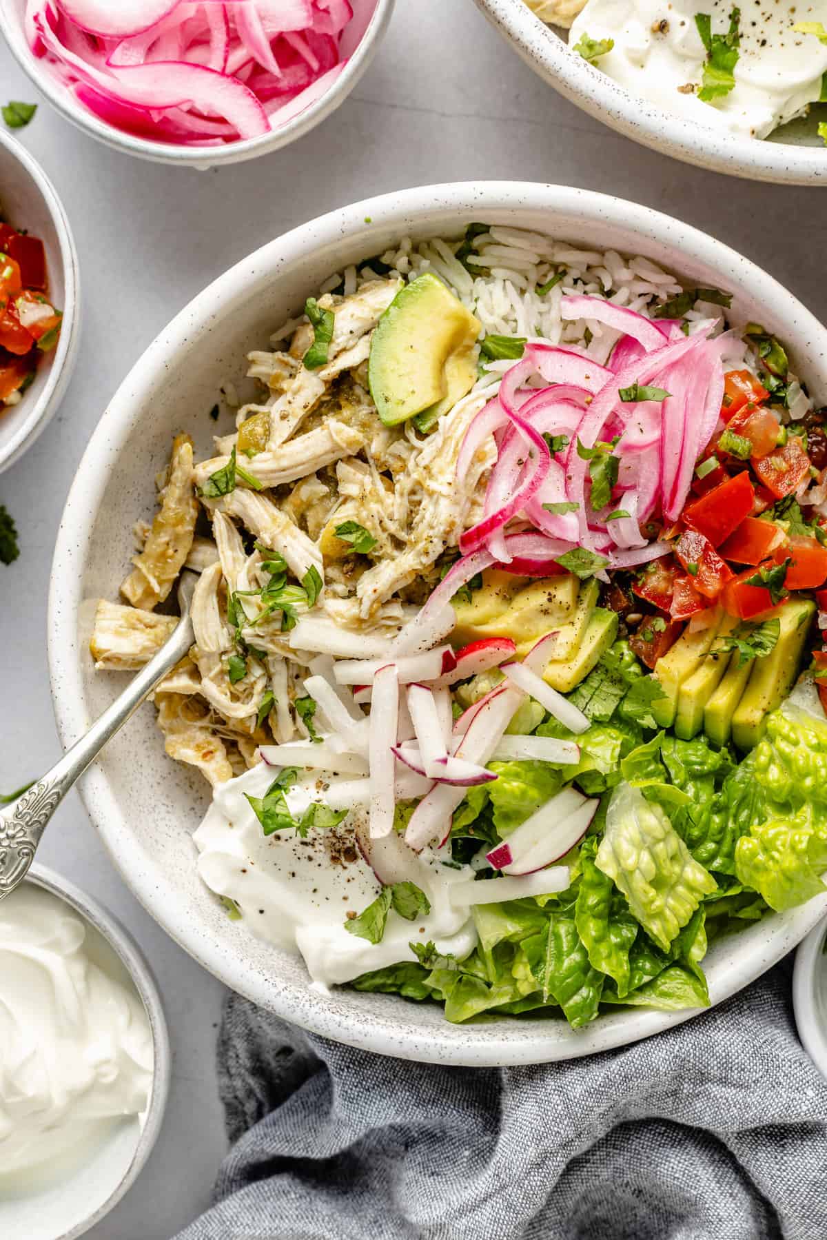 shredded chicken in bowl with toppings