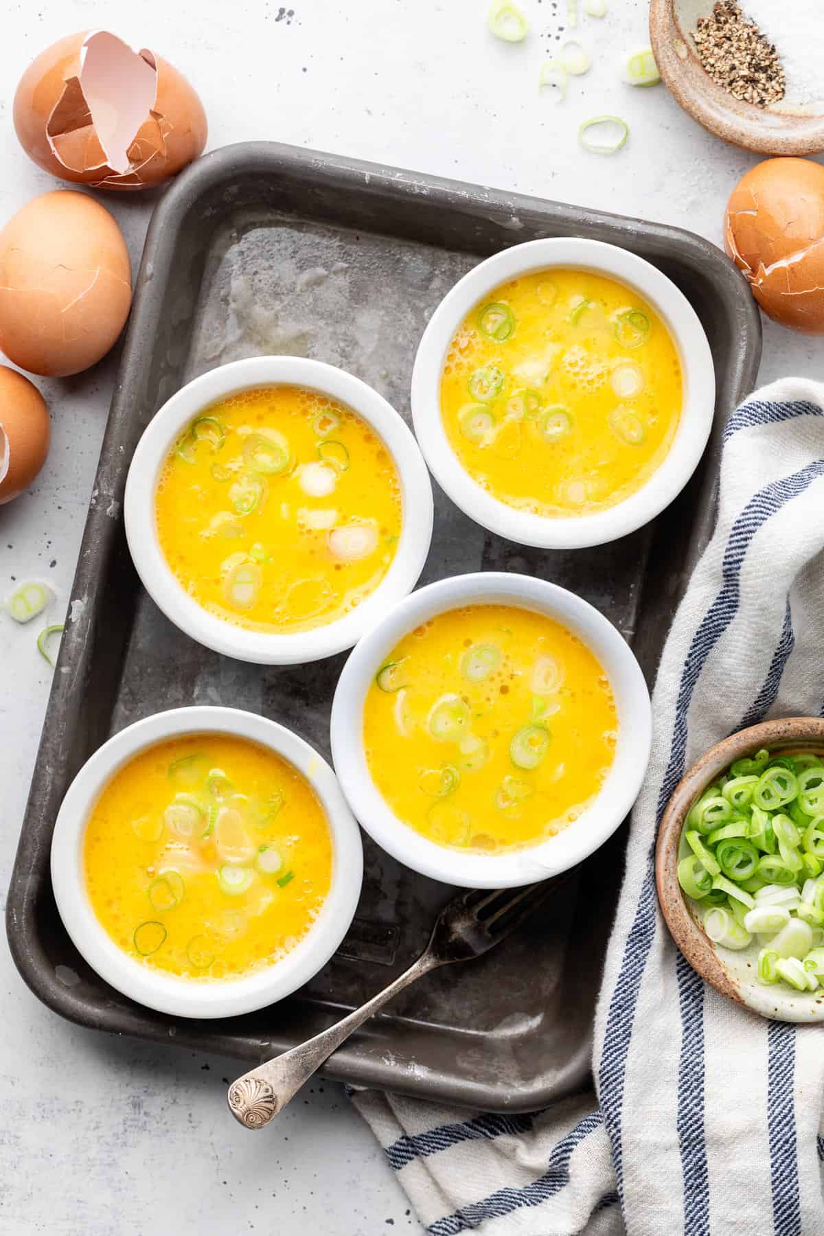 eggs in ramekins on sheet pan