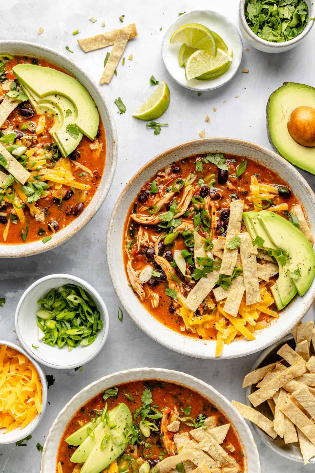 chicken tortilla soup in bowls with toppings