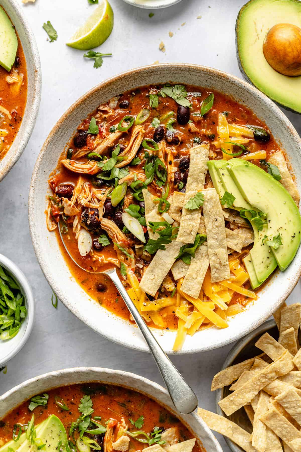 healthy chicken tortilla soup in bowl with spoon