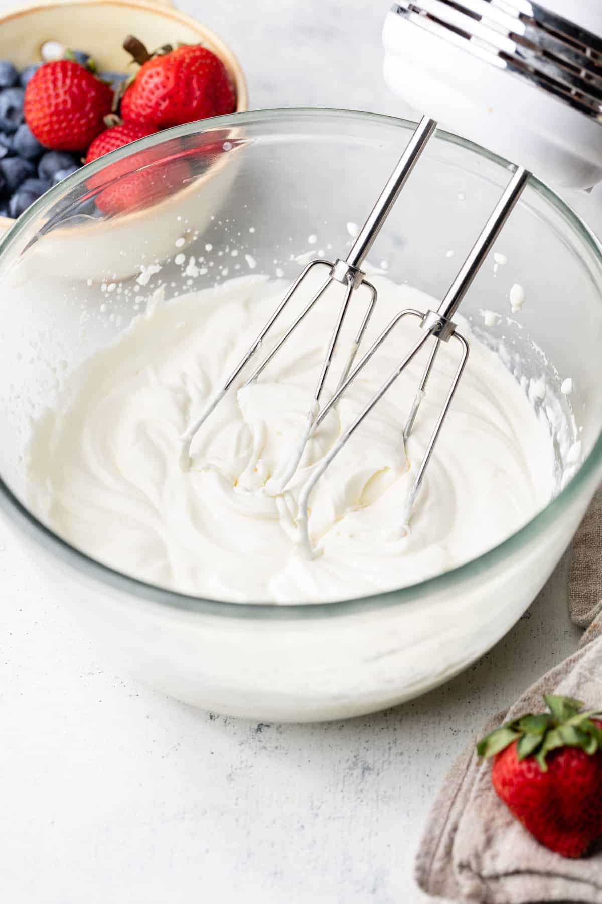 whipped cream being beat in bowl