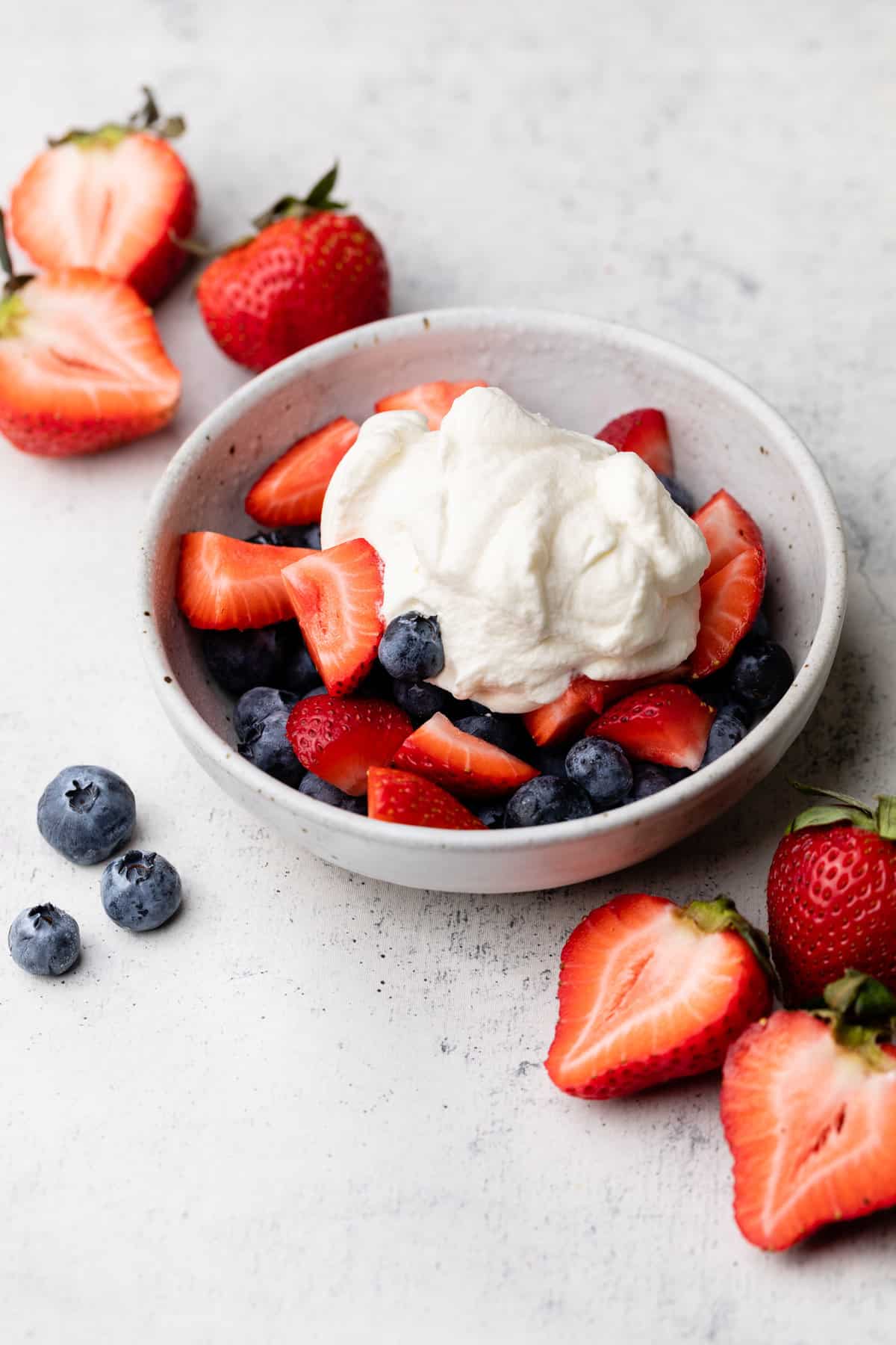 cream and berries in bowl