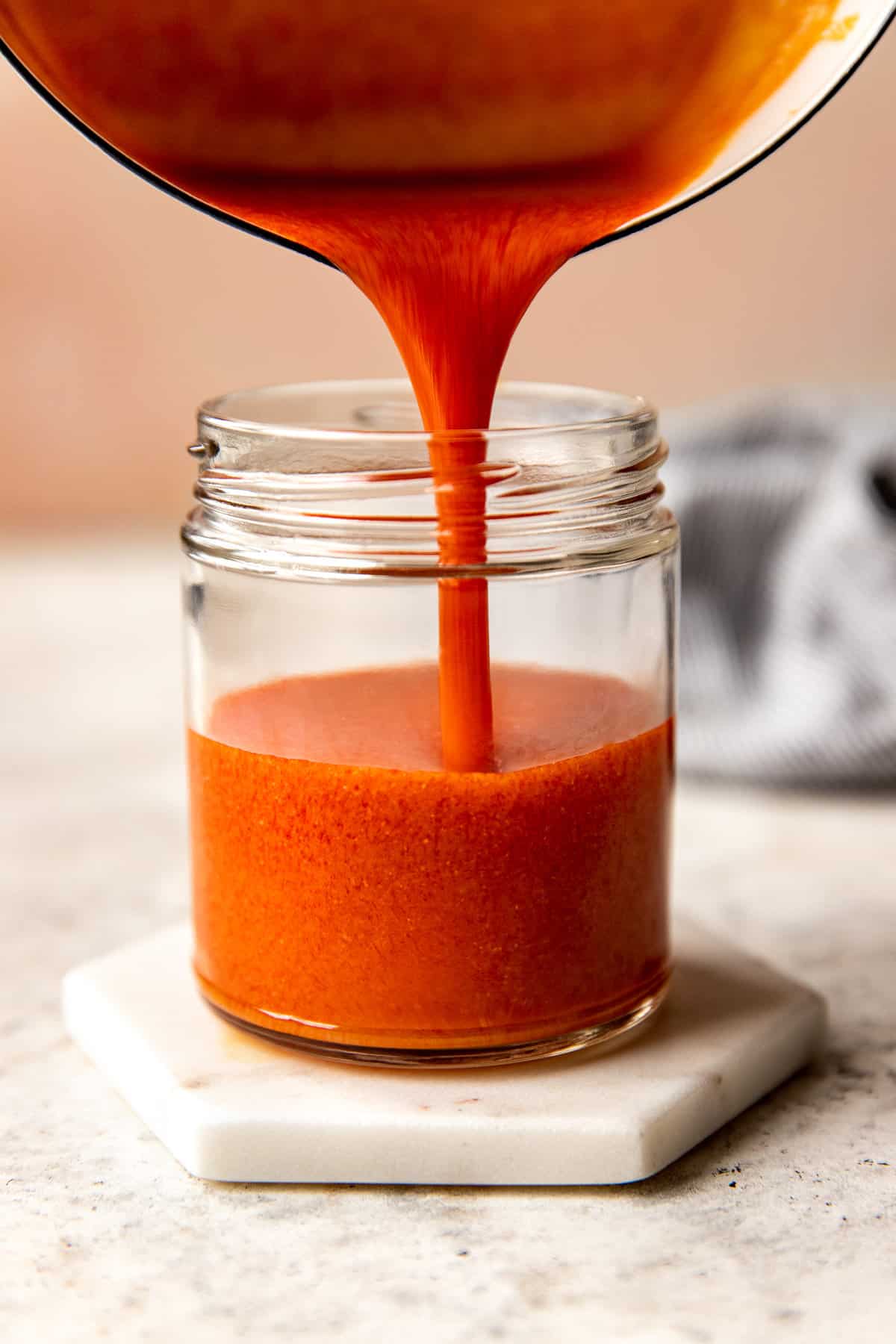 sauce being poured into jar