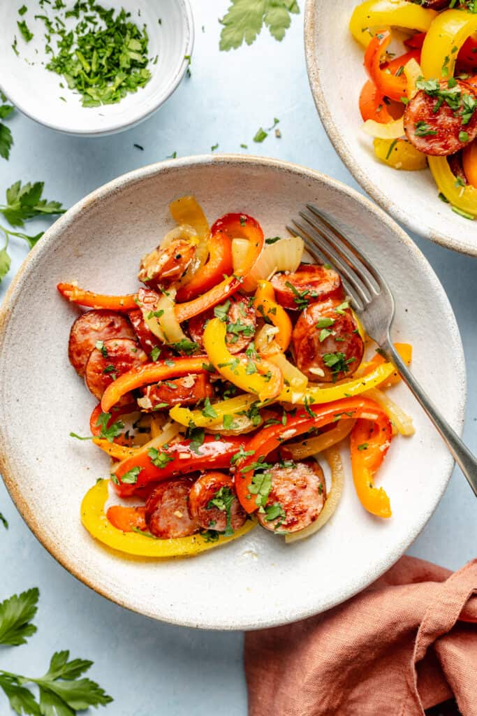 sausage and peppers in bowl with fork