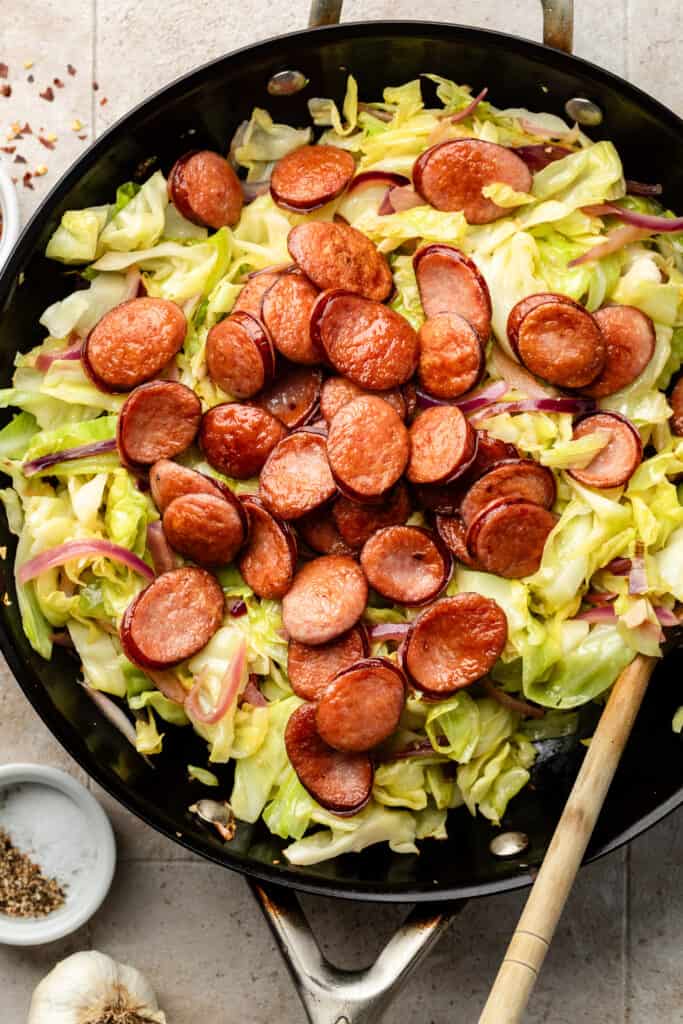 browned sausage and cabbage in skillet 