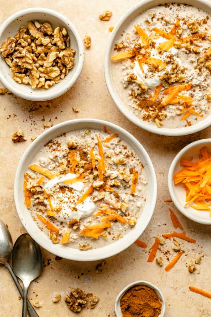 overnight oats in bowls with grated carrot and yogurt