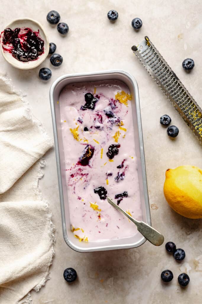 lemon blueberry cottage cheese mixture in loaf pan with spoon