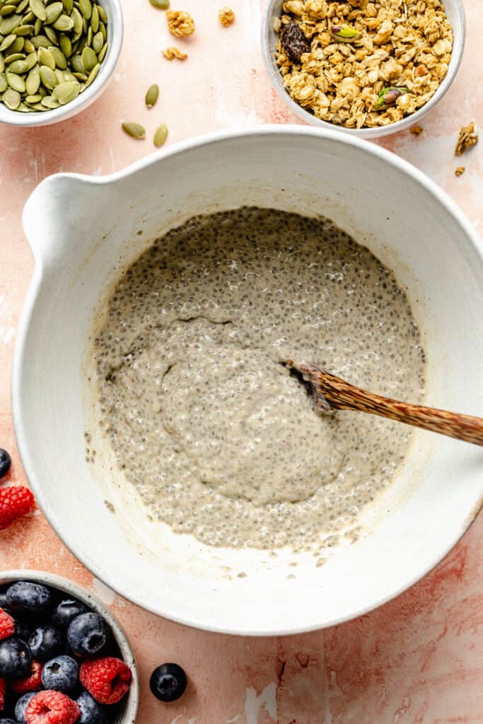 chia seed pudding being mixed in white bowl