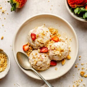 strawberry cheesecake cottage cheese ice cream scooped in bowl with spoon