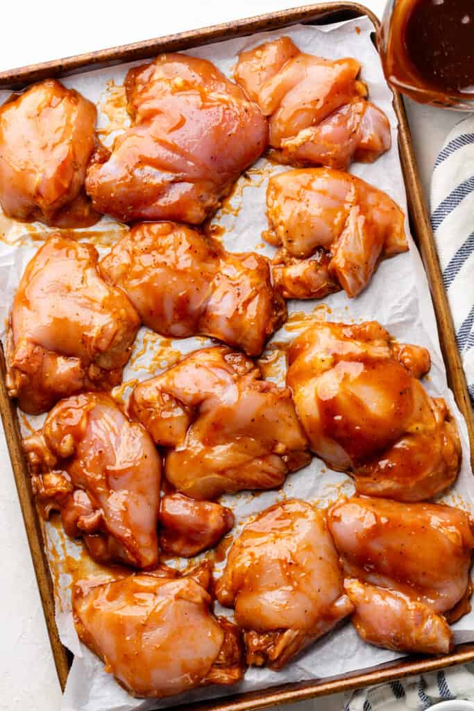raw chicken thighs on sheet pan 