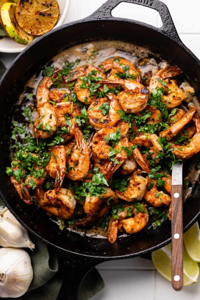 shrimp and cilantro in skillet with serving fork