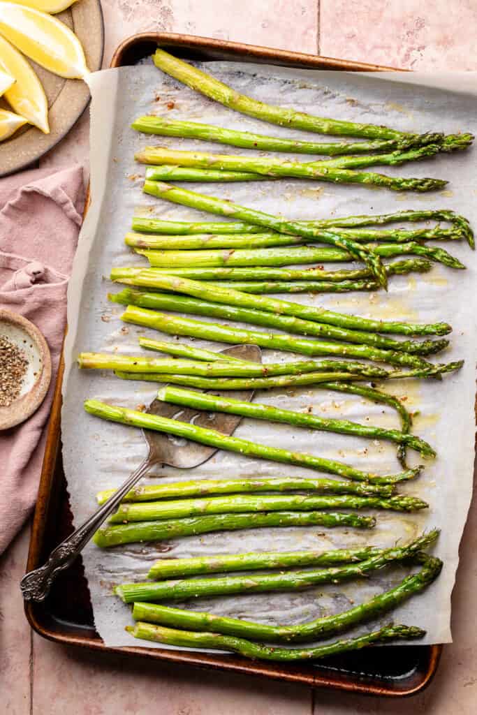 cooked asparagus spears on sheet pan
