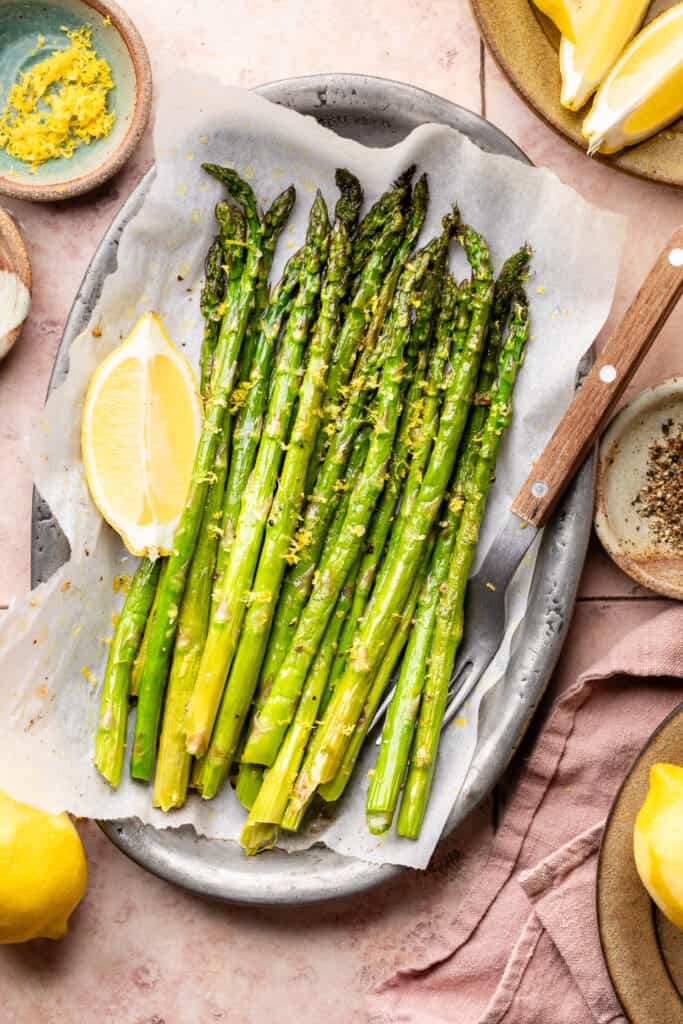 asparagus on sheet pan with fresh lemon
