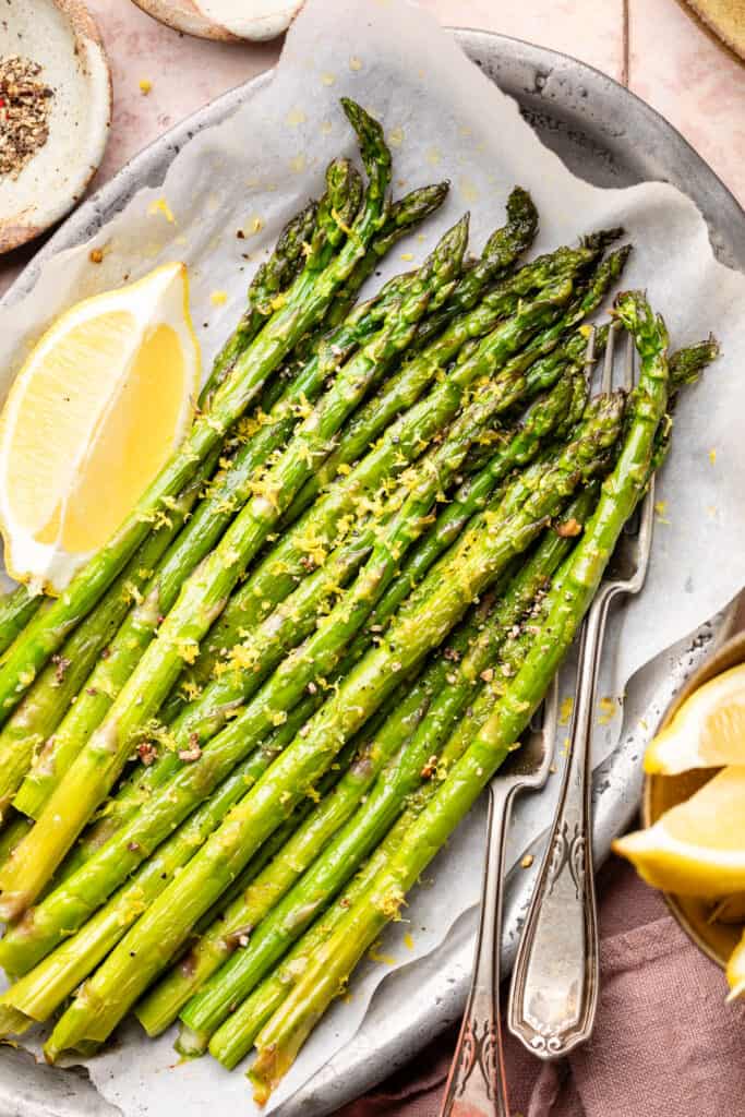 asparagus on sheet pan with fresh lemon