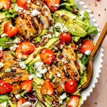 salad with serving spoon in white bowl