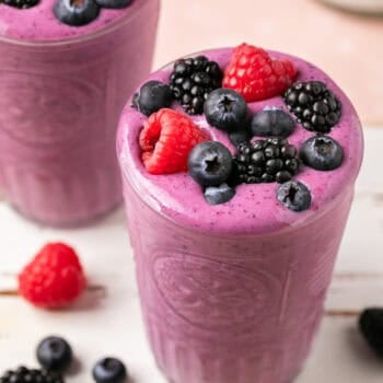 smoothie in glass topped with berries