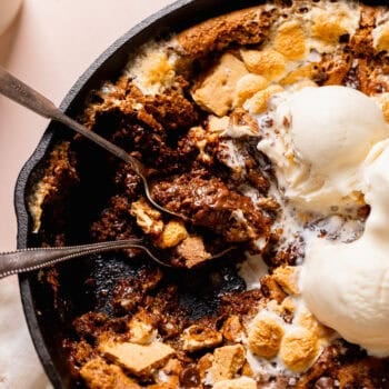 skillet cookie with two spoons and two scoops of ice cream