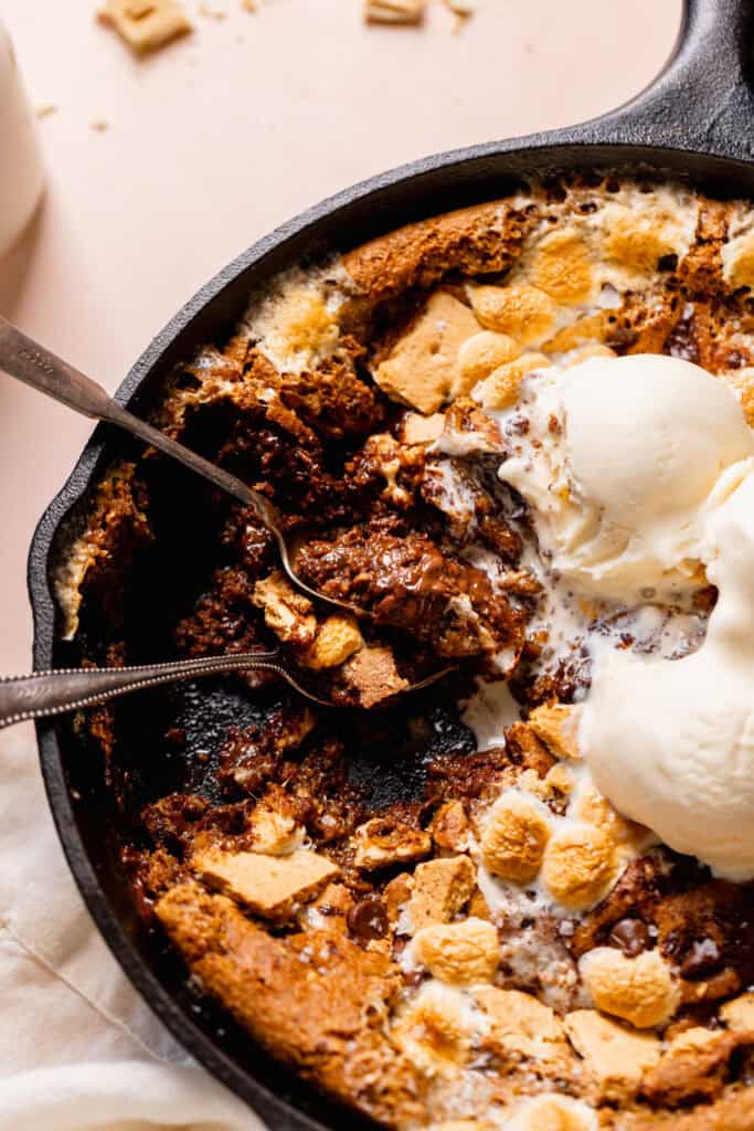 skillet cookie with two spoons and two scoops of ice cream