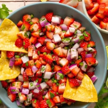 strawberry salsa in blue bowl with tortilla chips