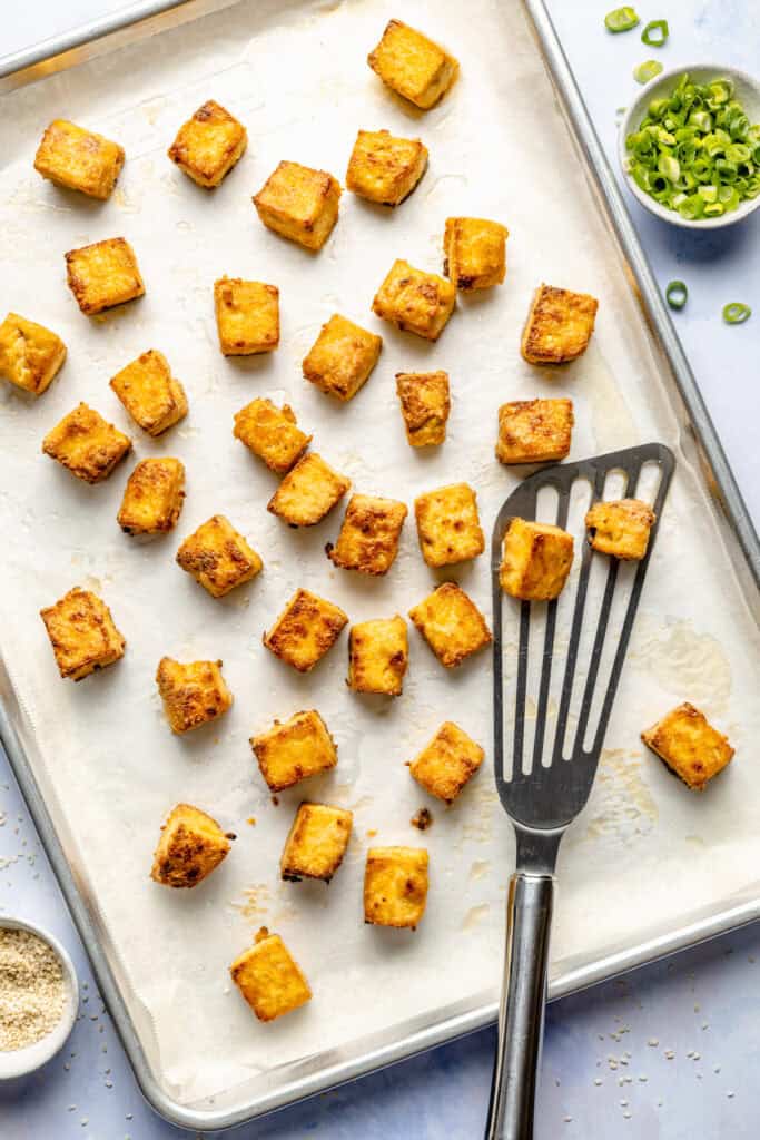 baked tofu on sheet pan with spatula