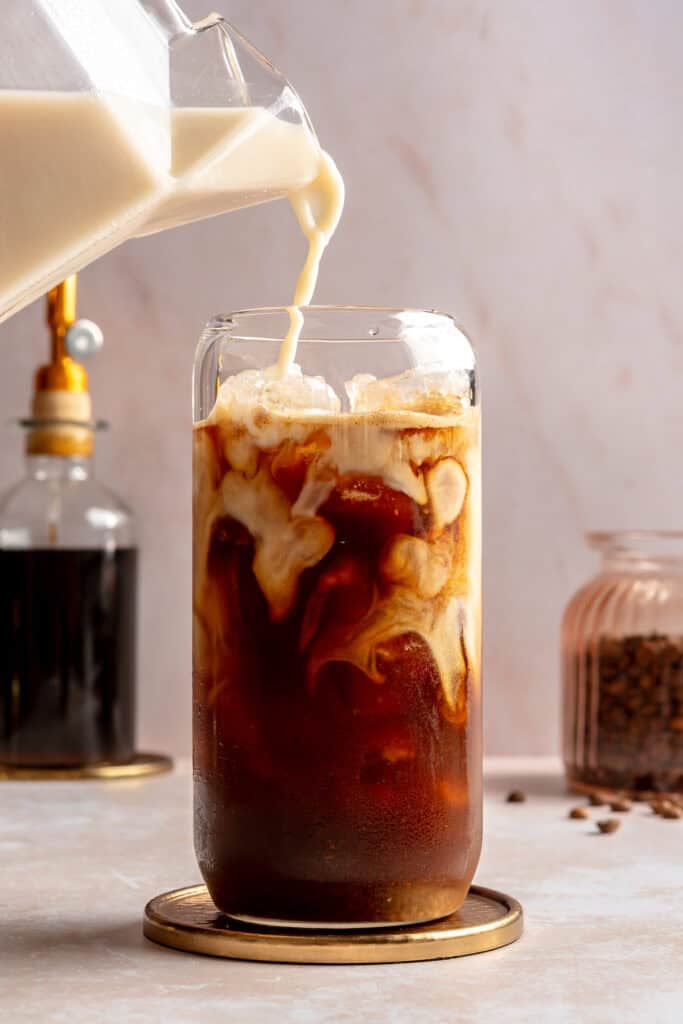 oat milk being poured into glass