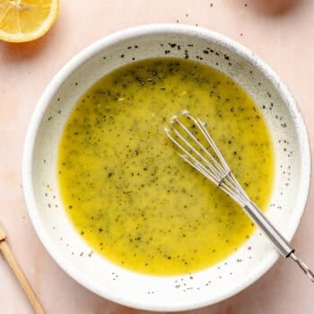 poppy seed dressing in small bowl with whisk